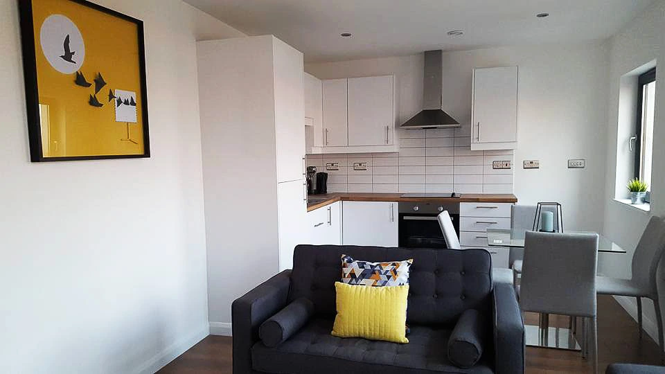 Inside of on of the Ardenhouse apartments showing couch and kitchen area.